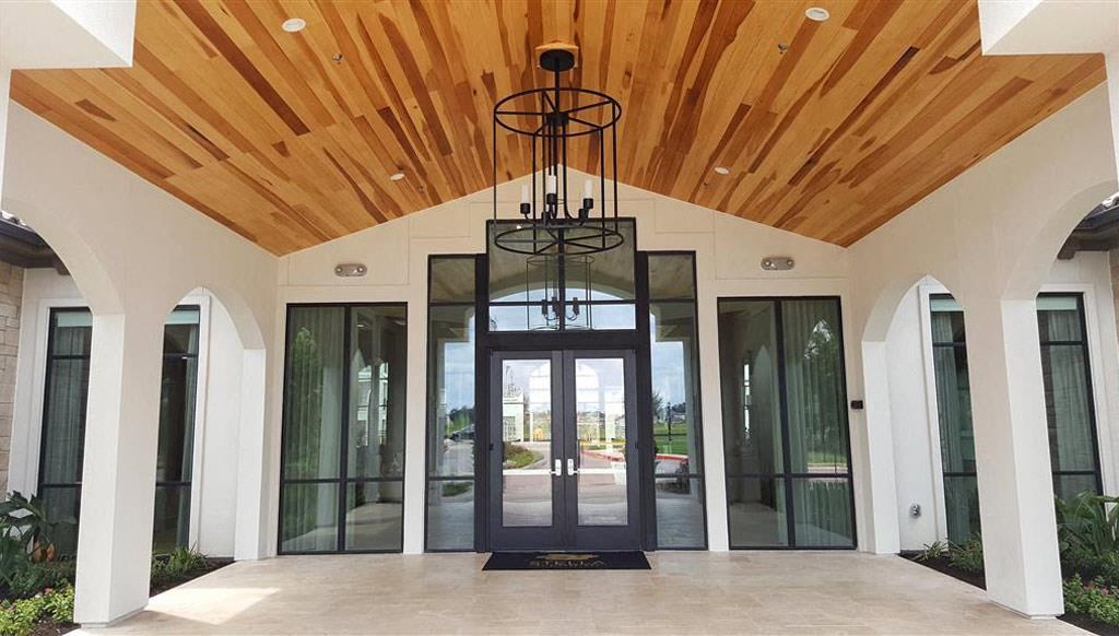 a lobby with a wooden ceiling and glass doors