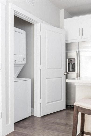 a kitchen with white cabinets and a white door