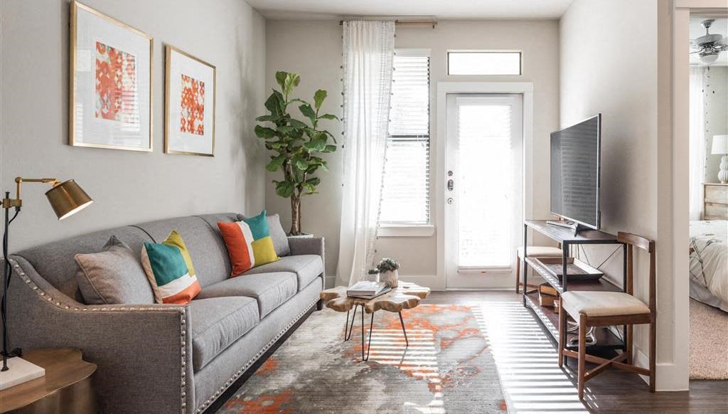 a living room with a couch and a piano