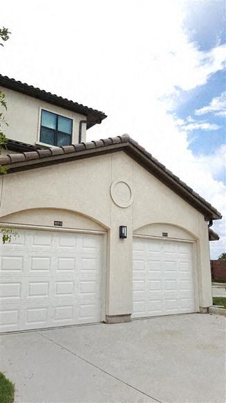 a white house with two white garage doors