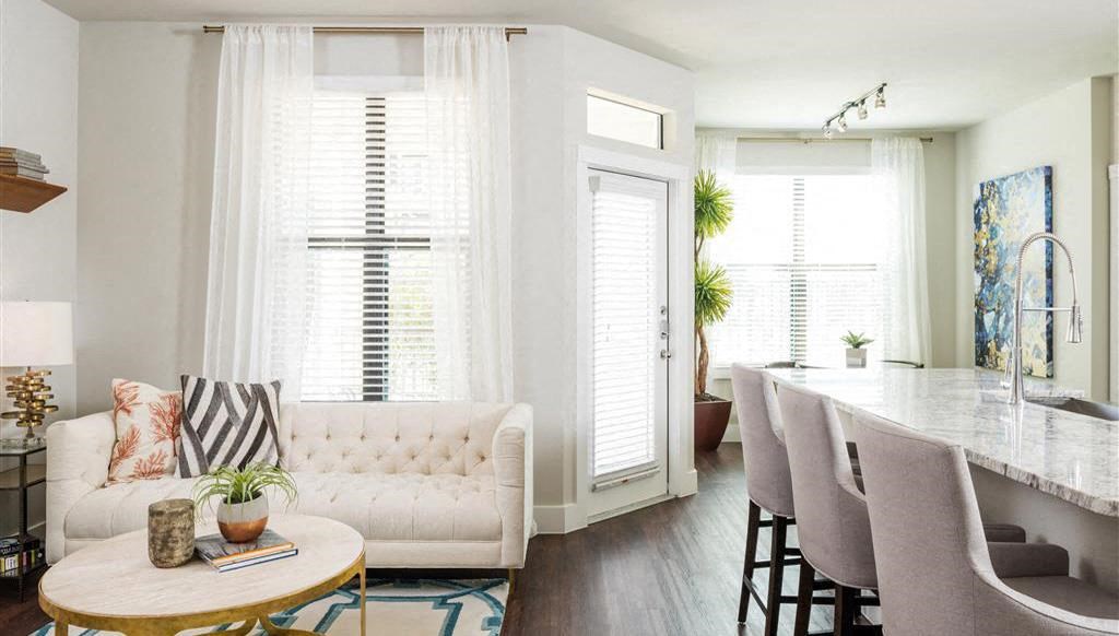 a living room and kitchen with a table and chairs