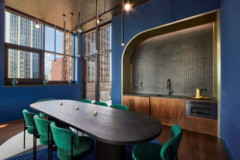 A modern dining room with a large table and chairs.
