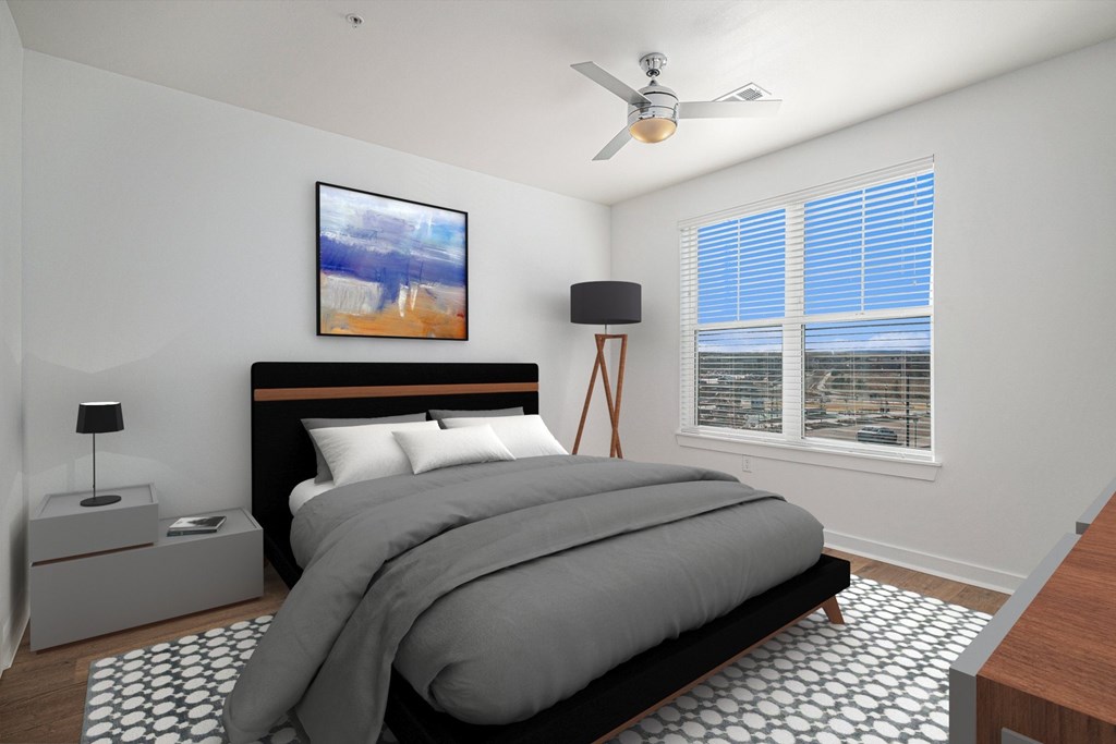 A bedroom with a large bed and a painting on the wall.