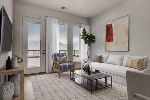 A living room with a couch, a chair, a coffee table, and a painting on the wall.
