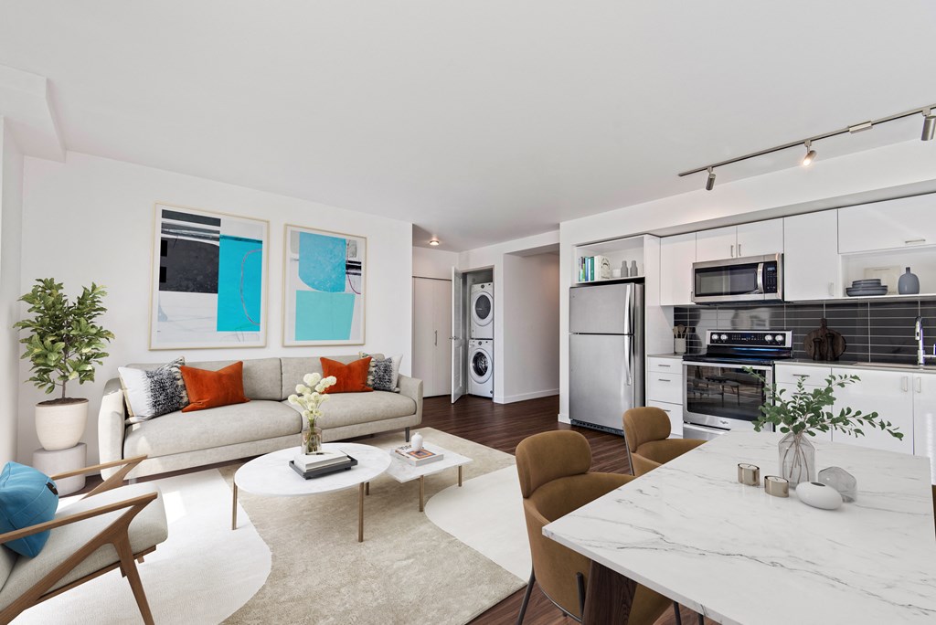 a living room with a kitchen and a couch and a table