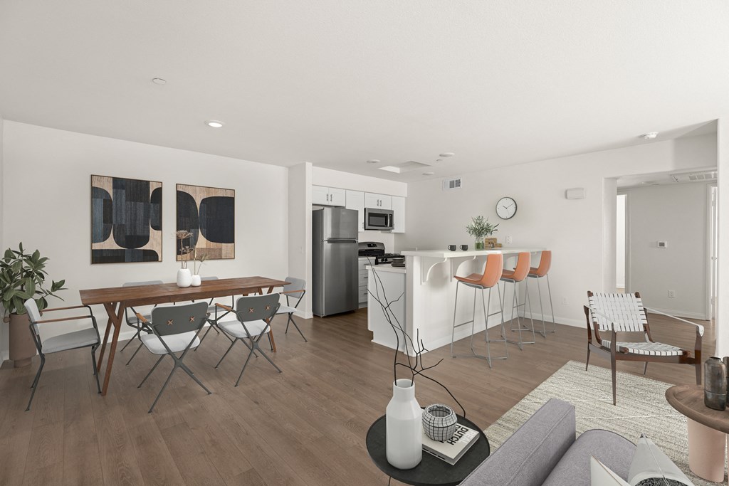 a living room and dining room with a table and chairs