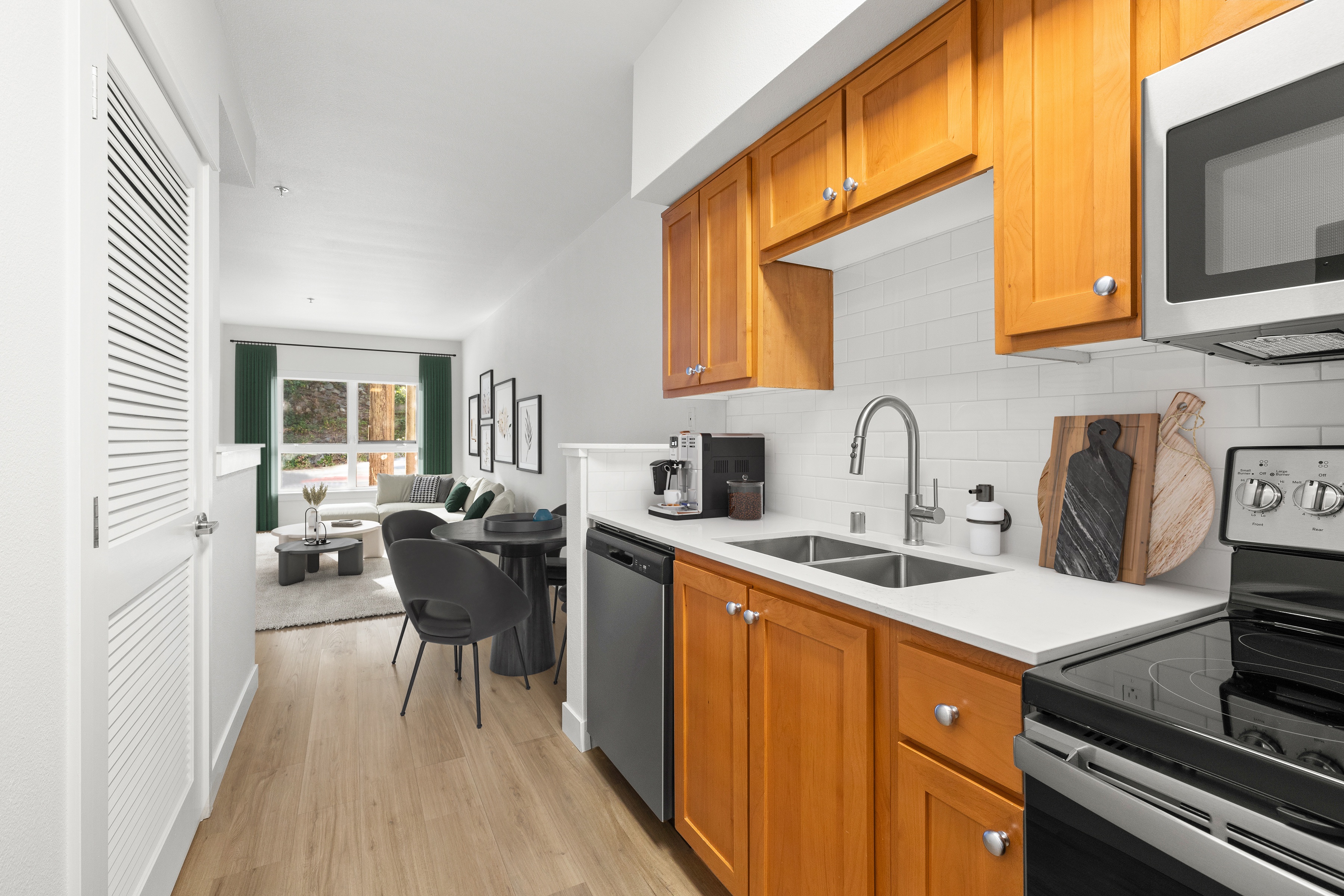 A kitchen with wooden cabinets and a black stove top oven.