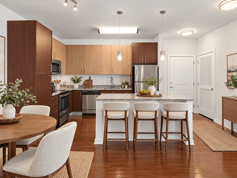 A kitchen with a table and chairs.