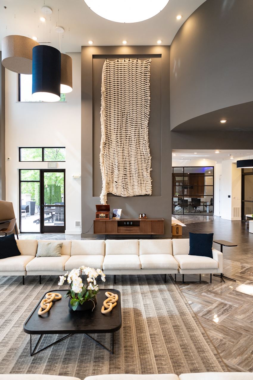 a living room filled with furniture and a large painting on a wall