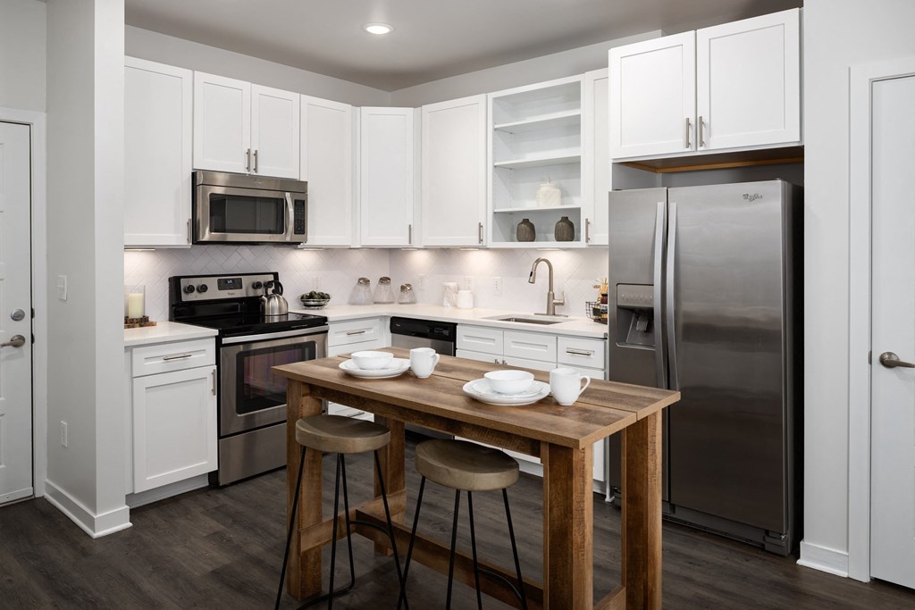 a kitchen with white cabinetry and stainless steel appliances