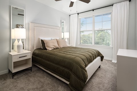 a bedroom with a bed and a ceiling fan