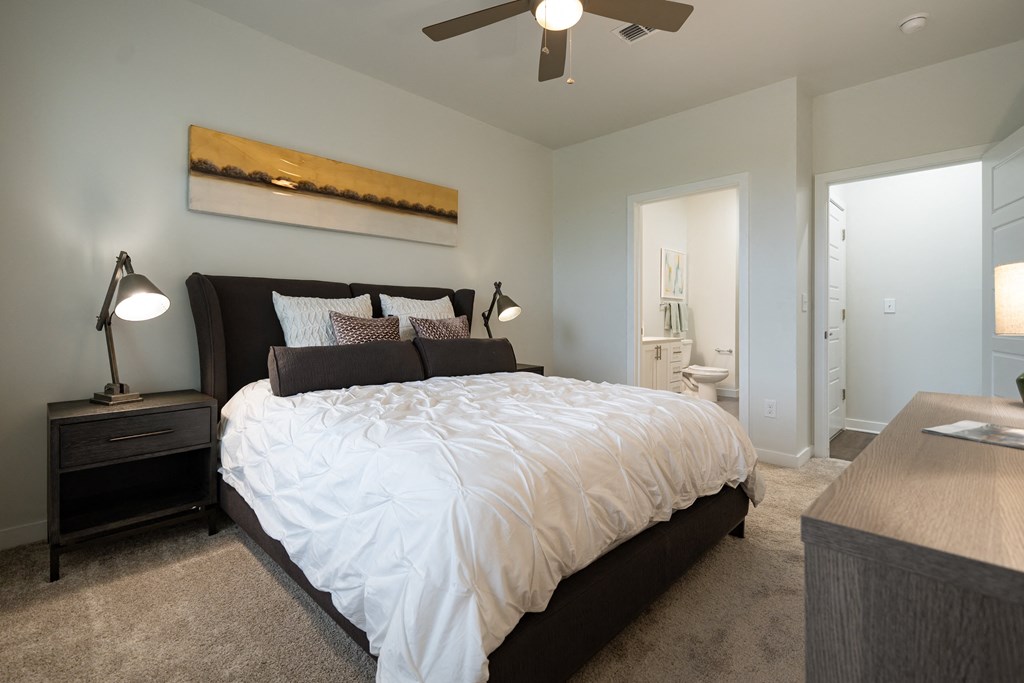 a bedroom with a bed and a ceiling fan