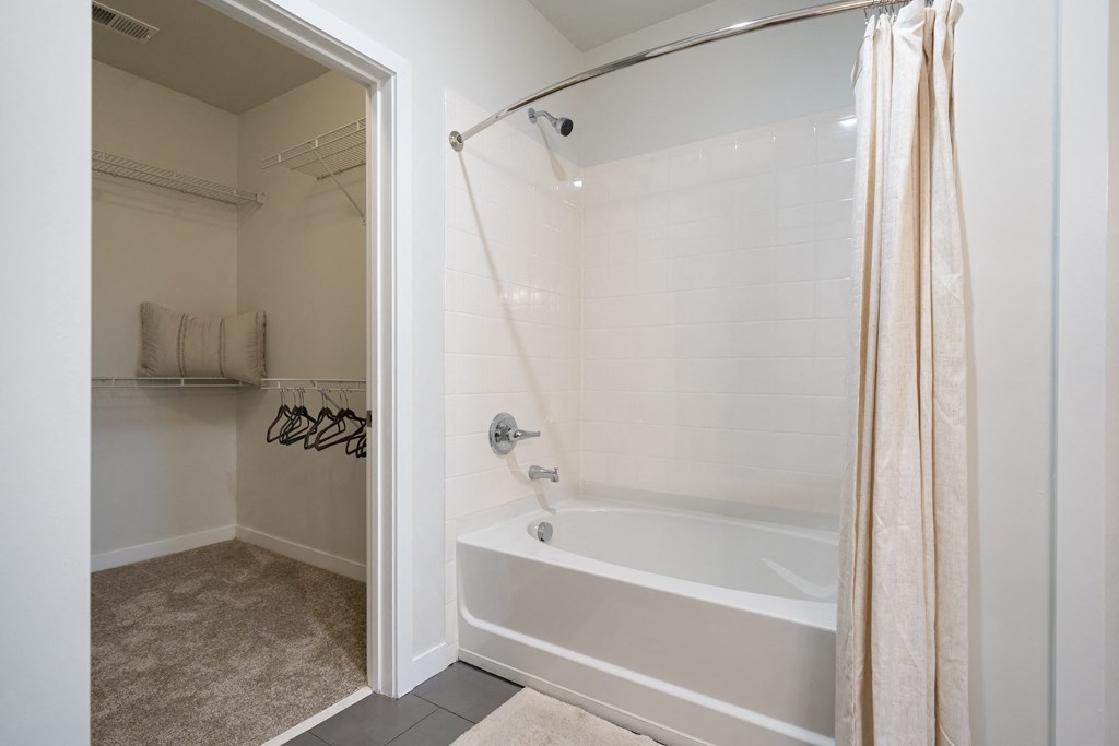 a bathroom with a bathtub and shower