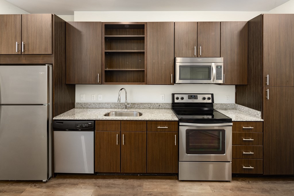 a kitchen with wooden cabinets and stainless steel appliances