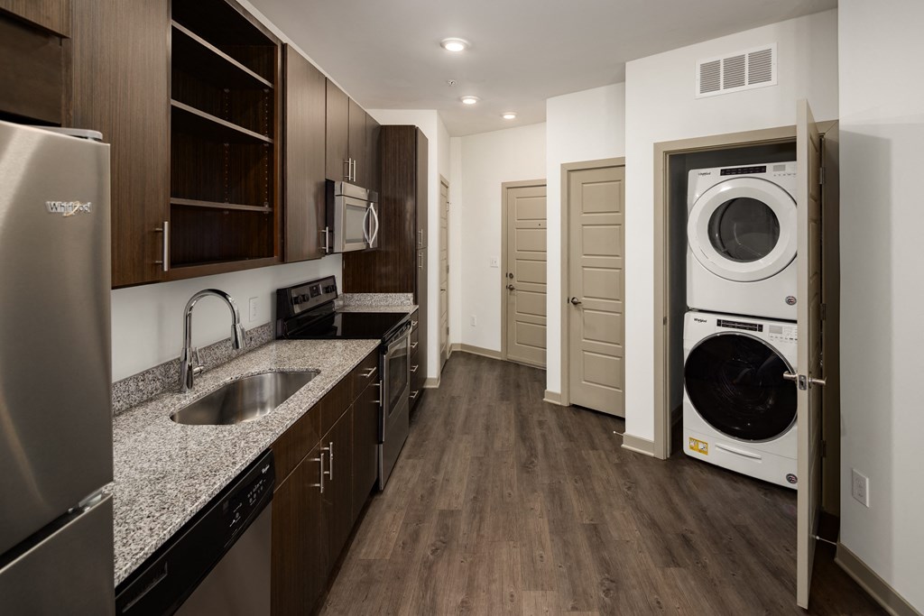 a kitchen with a sink and a washer and dryer
