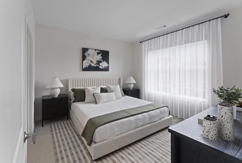 A bedroom with a large bed and a painting above it.