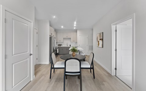 A dining room with a table set for four.