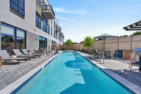 A long rectangular pool with a white border and blue water.