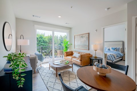 a living room with a couch and a table and a balcony