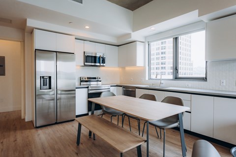 A modern kitchen with a table and chairs.