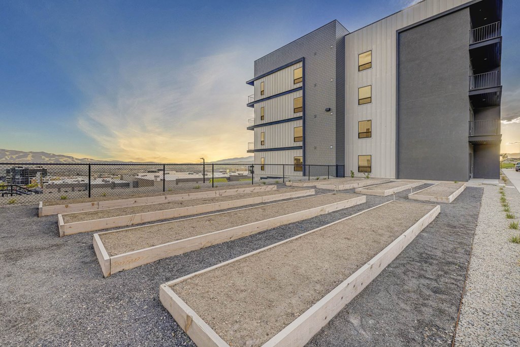 A modern building with a parking lot in front of it.