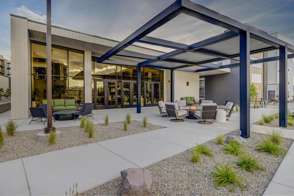 A modern house with a covered outdoor seating area.