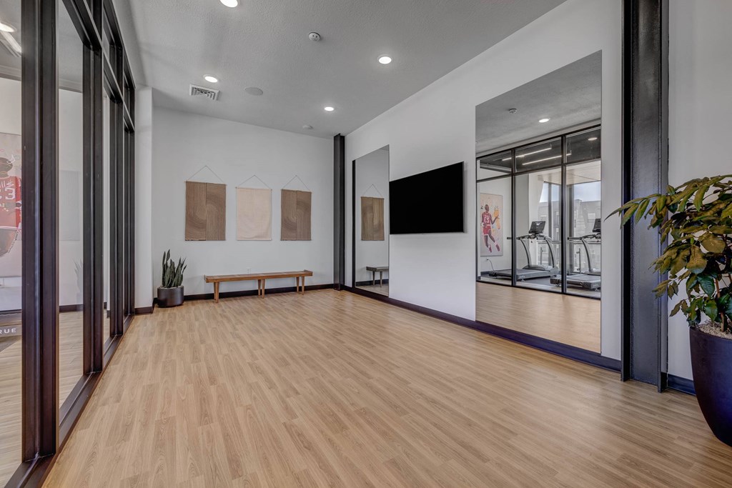 A room with wooden floors and a bench.