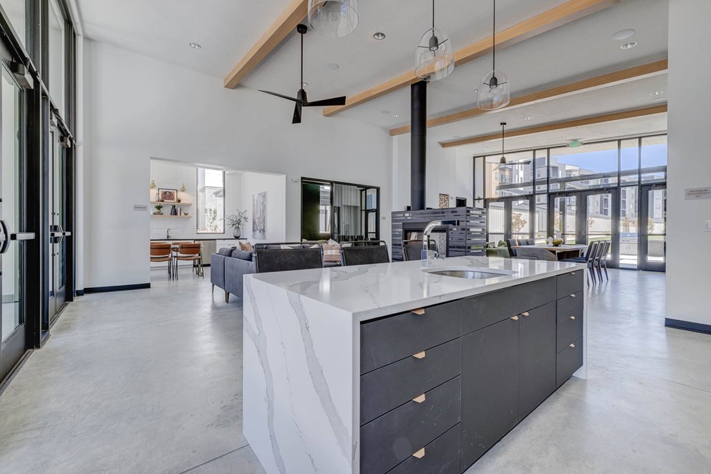 A modern kitchen with a large island and a view of the city.