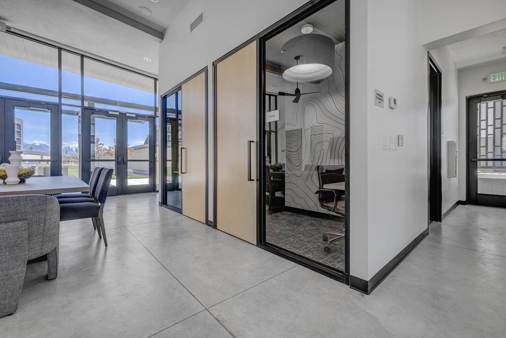 A modern interior with a dining area and a view of the city.