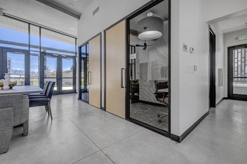 A modern interior with a dining area and a view of the city.