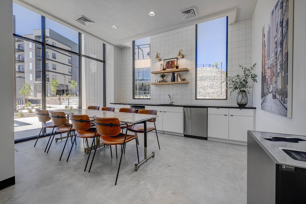 A modern kitchen with a dining table and chairs.