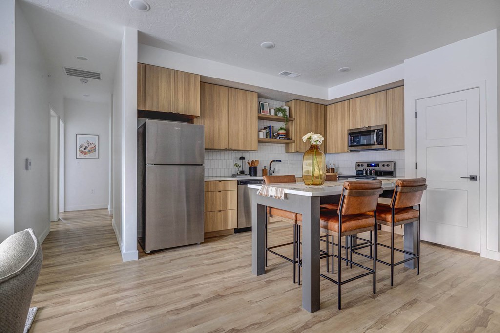 a kitchen with stainless steel appliances and wooden cabinets