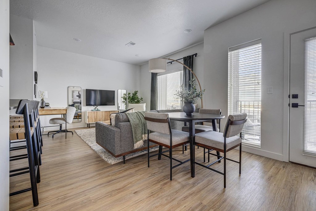 an open living room with a dining room table and chairs