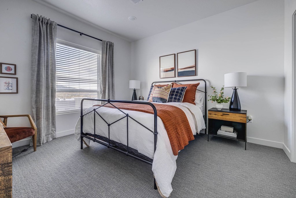 a bedroom with a bed and a large window