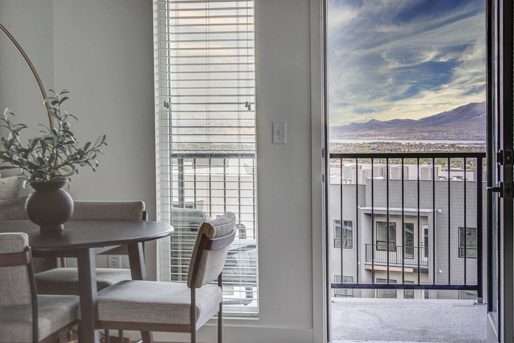 Dining room area with a view of the personal balcony and a view of mountains