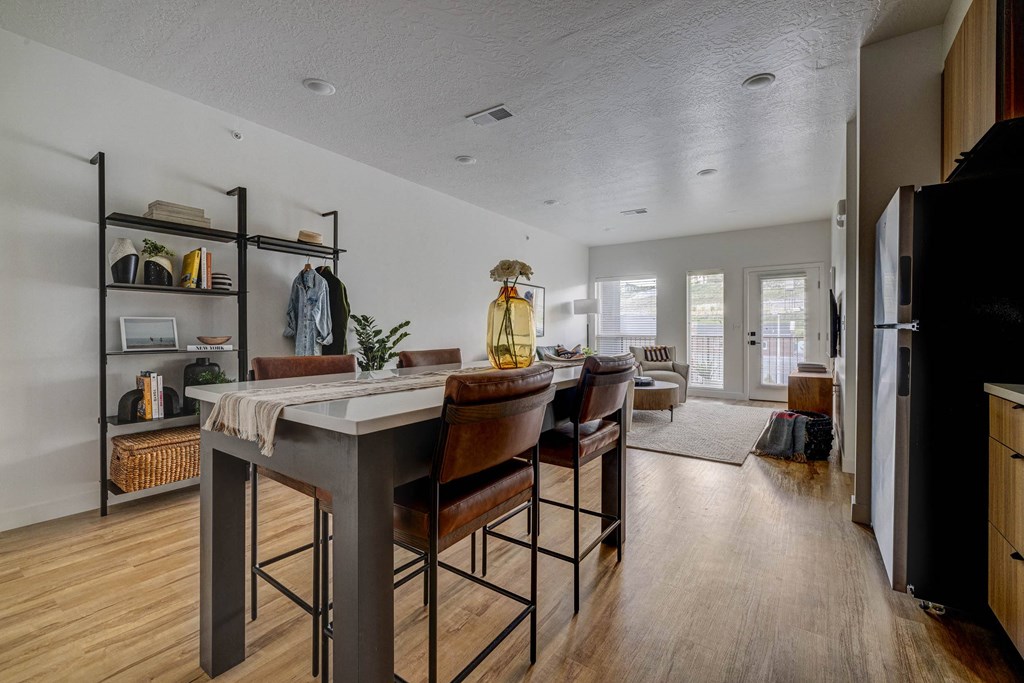 an open kitchen with a large island with four stools