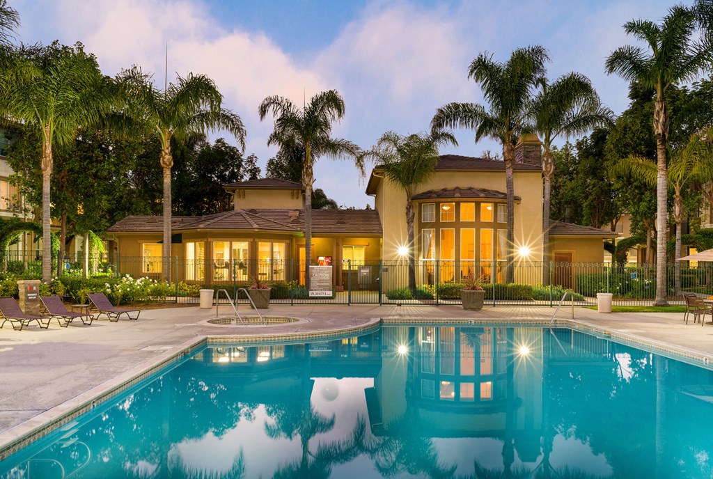 A house with a pool in front of it.