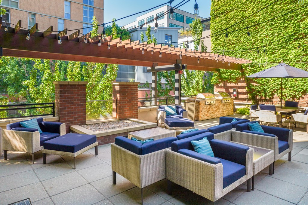 an outdoor patio with couches and a fire pit