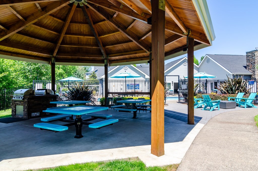 a large pavilion with picnic tables and a grill at The Arden Apartments, Gresham, OR