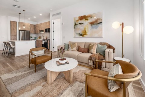A living room with a brown chair and a white coffee table.