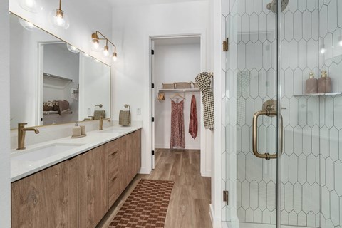A bathroom with a white sink and a mirror above it.