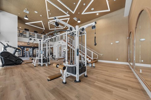 A gym with a variety of equipment including a leg press machine.