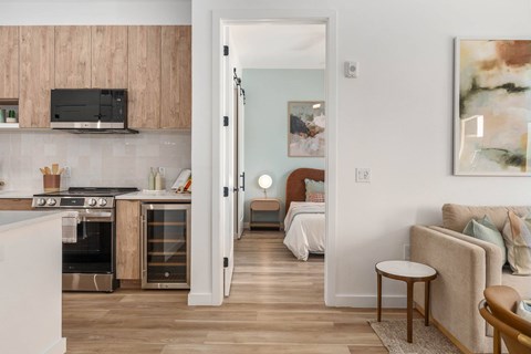 A modern kitchen with wooden cabinets and a stainless steel oven.
