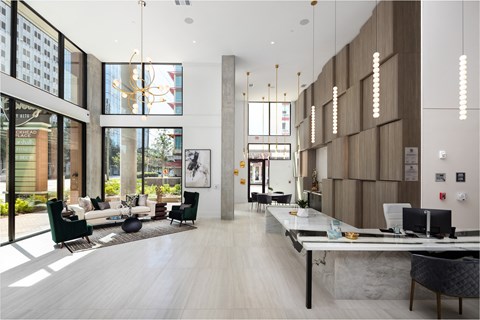 a large living room with high ceilings and large windows