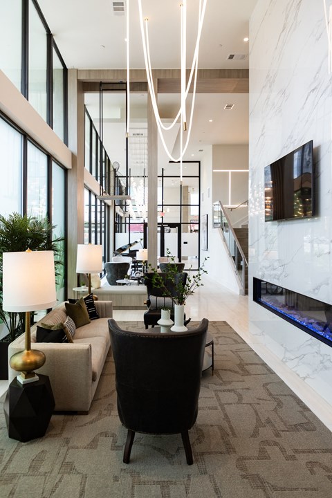 a living room with a couch and a chair and a fireplace