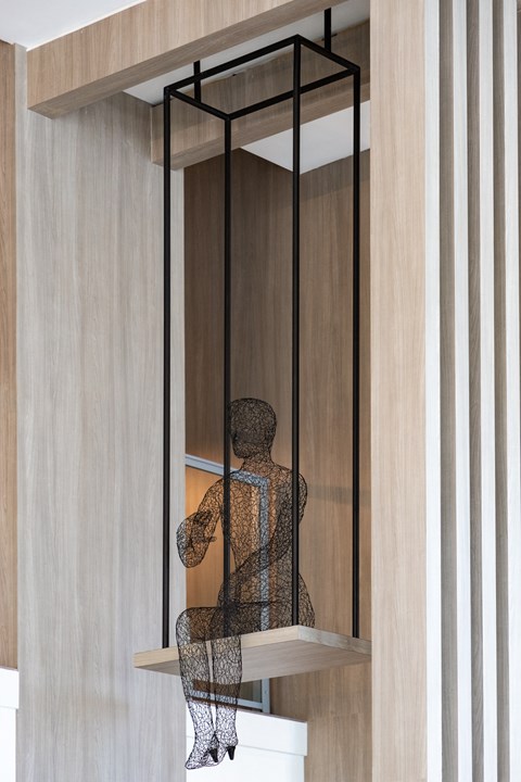 a sculpture of a person in a glass case on a shelf