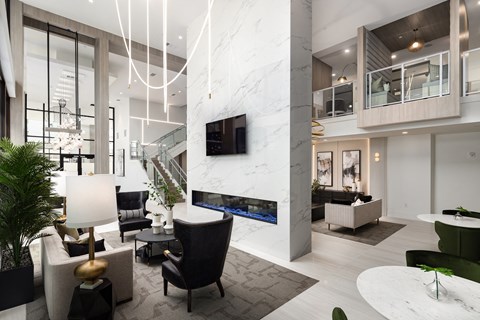 a large living room with a marble fireplace and a tv