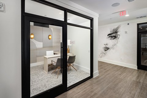 a conference room with glass doors and a table with chairs and a large wall mural