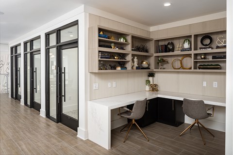 a home office with a desk and sliding glass doors