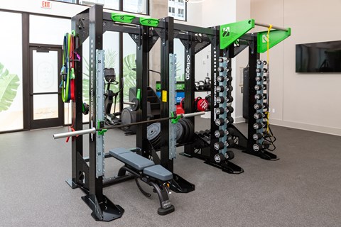 a fitness room with weights and other gym equipment